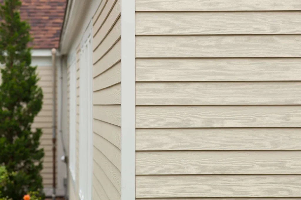 A residential home featuring clean tan lap siding Grand Prairie TX installation with weather-tight corner posts and window trims
